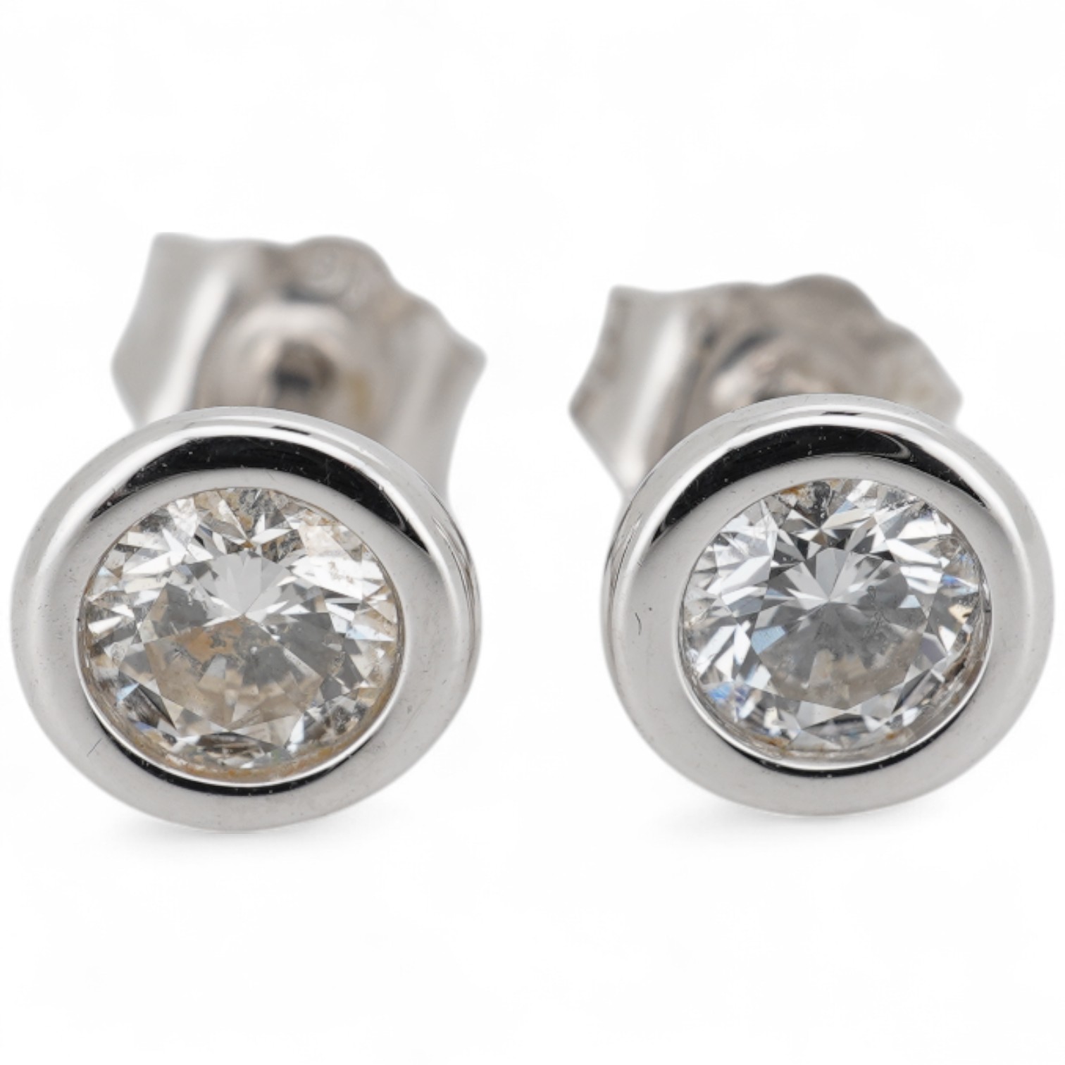 A modern pair of white metal (stamped 375) and solitaire lab-grown synthetic diamond set ear studs, each stone weighing approximately 0.15-0.20ct.